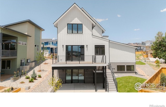 914 Eldorado Ln, Louisville, CO 80027 - rear view of property with fence, a balcony, board and batten siding, a patio area, and stairway