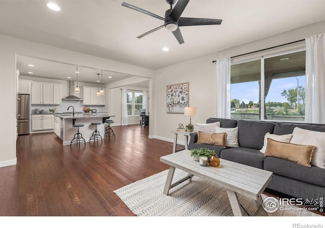 5845 Shadow Creek Ct, Windsor, CO 80528 - living area featuring a ceiling fan, baseboards, dark wood-style flooring, and recessed lighting