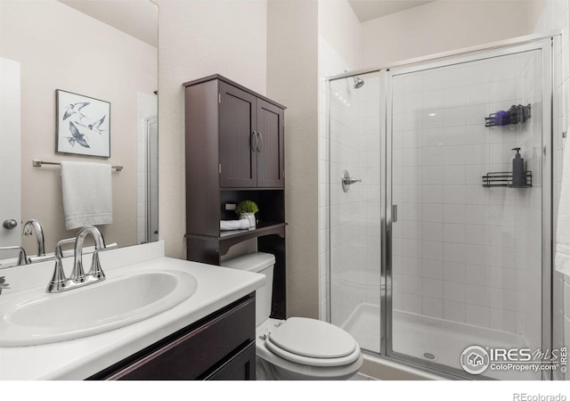 5845 Shadow Creek Ct, Windsor, CO 80528 - bathroom featuring toilet, a shower stall, and vanity