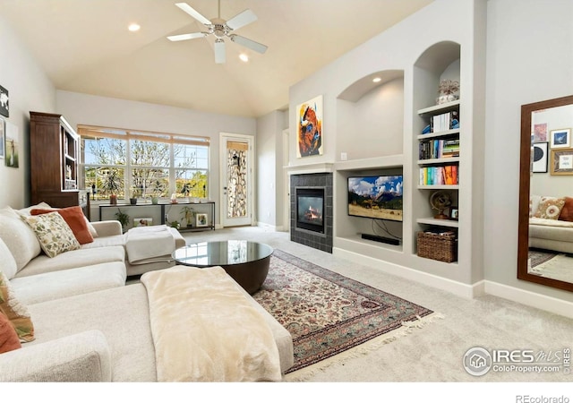 1992 Vineyard Dr, Windsor, CO 80550 - living room featuring built in shelves, baseboards, a ceiling fan, and a tile fireplace