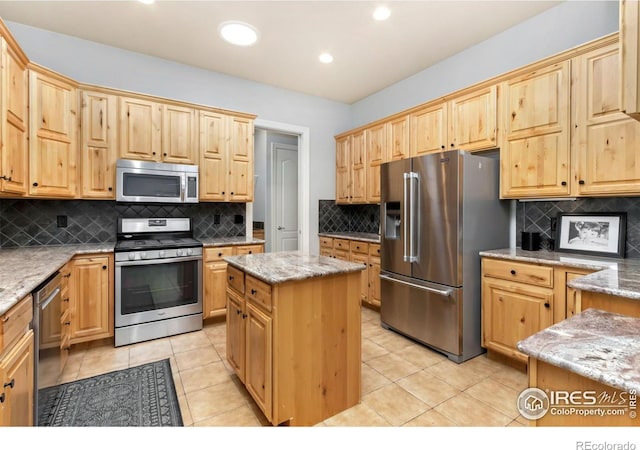 1992 Vineyard Dr, Windsor, CO 80550 - kitchen featuring stainless steel appliances, light stone counters, and decorative backsplash