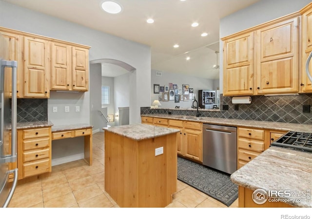 1992 Vineyard Dr, Windsor, CO 80550 - kitchen with stainless steel dishwasher, light tile patterned flooring, a sink, and light brown cabinets