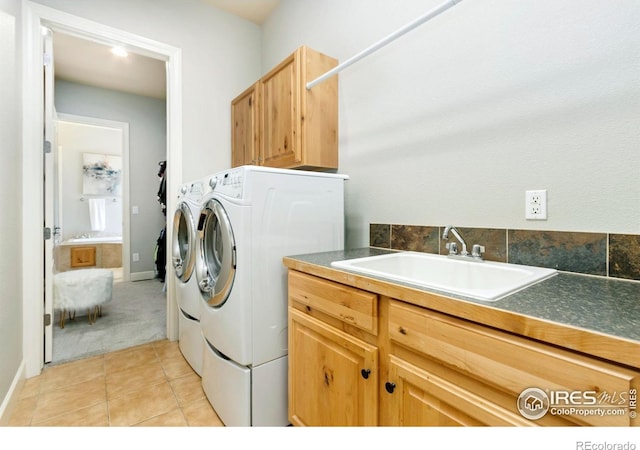 1992 Vineyard Dr, Windsor, CO 80550 - laundry room with washer and dryer, cabinet space, light carpet, a sink, and light tile patterned floors