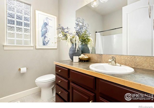 1992 Vineyard Dr, Windsor, CO 80550 - bathroom featuring vanity, toilet, tile patterned floors, baseboards, and curtained shower