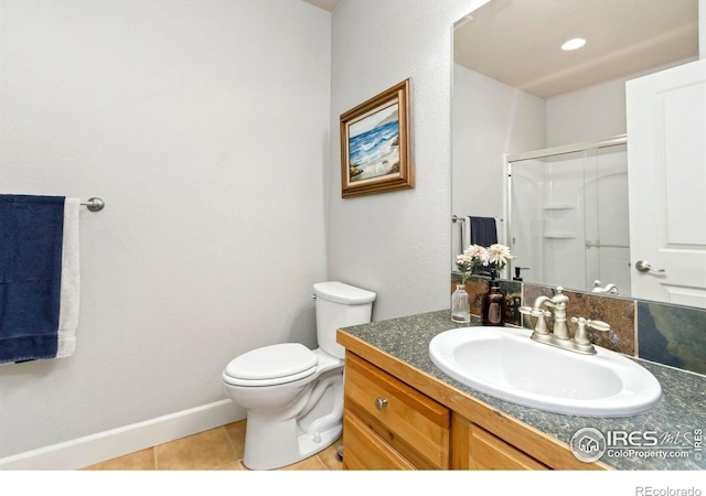 1992 Vineyard Dr, Windsor, CO 80550 - full bath with tile patterned flooring, vanity, toilet, baseboards, and a shower stall