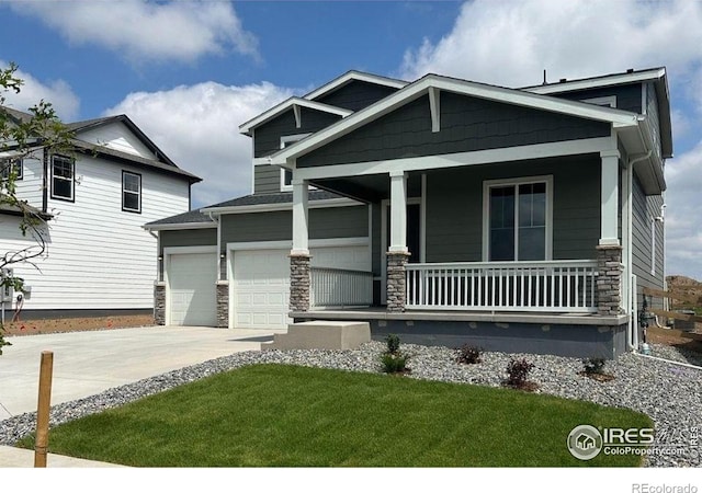 842 Mesic Ln, Windsor, CO 80550 - craftsman-style home with a porch, driveway, a garage, stone siding, and a front lawn