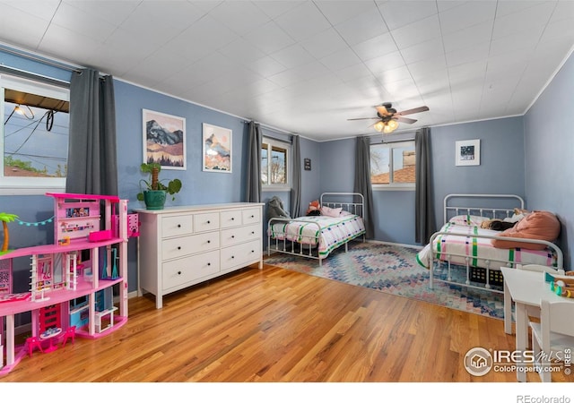 9261 Julian Way, Westminster, CO 80031 - bedroom with ornamental molding, a ceiling fan, and wood finished floors