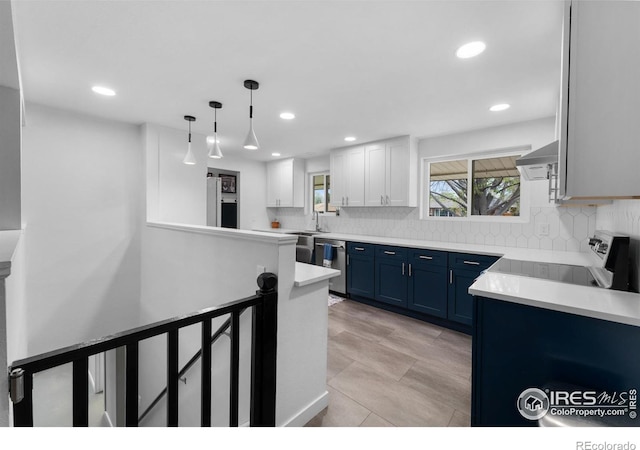 9261 Julian Way, Westminster, CO 80031 - kitchen with recessed lighting, blue cabinets, appliances with stainless steel finishes, and tasteful backsplash