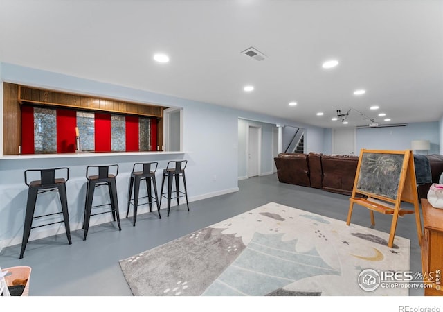 9261 Julian Way, Westminster, CO 80031 - interior space featuring finished concrete flooring, baseboards, stairway, and visible vents