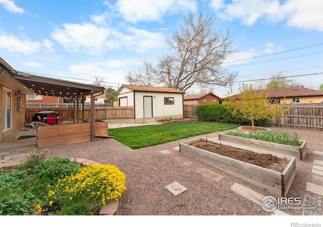9261 Julian Way, Westminster, CO 80031 - view of yard with an outdoor structure, a fenced backyard, and a vegetable garden