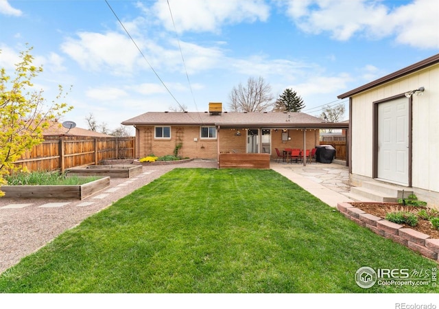 9261 Julian Way, Westminster, CO 80031 - rear view of property featuring a lawn, a patio, a garden, and fence private yard