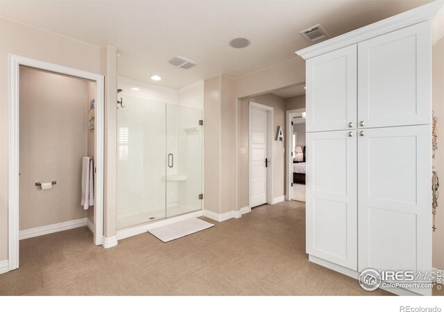 full bathroom featuring baseboards, visible vents, and a shower stall