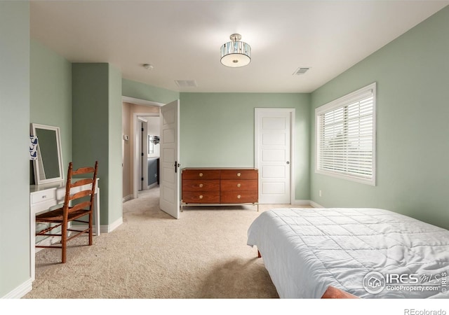bedroom with carpet floors, baseboards, and visible vents