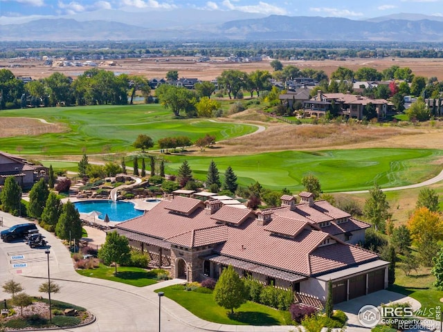 birds eye view of property featuring view of golf course and a mountain view