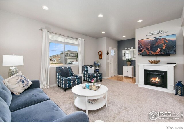 3803 Peach St, Wellington, CO 80549 - living area featuring carpet, recessed lighting, baseboards, and a glass covered fireplace