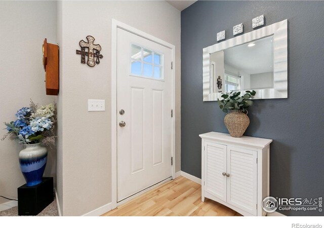3803 Peach St, Wellington, CO 80549 - foyer entrance with light wood-style floors and baseboards