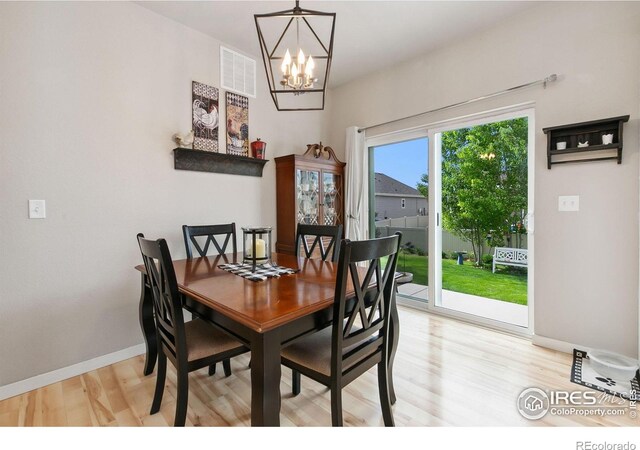 3803 Peach St, Wellington, CO 80549 - dining room featuring a chandelier, light wood-type flooring, and baseboards