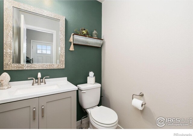 3803 Peach St, Wellington, CO 80549 - bathroom featuring toilet, vanity, and baseboards