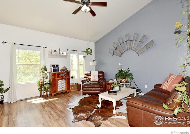 living area featuring visible vents, ceiling fan, wood finished floors, and high vaulted ceiling