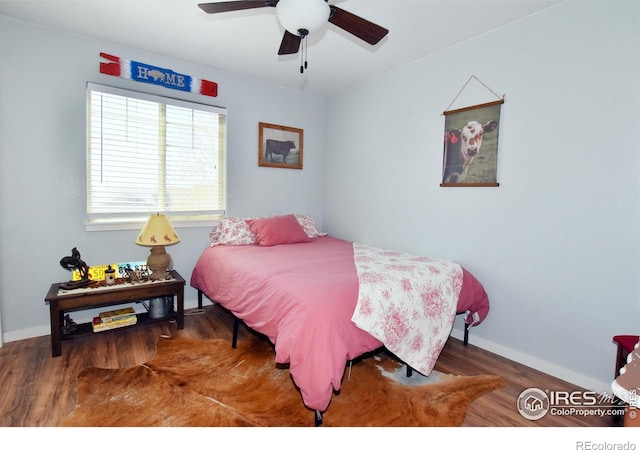 bedroom with baseboards, a ceiling fan, and wood finished floors