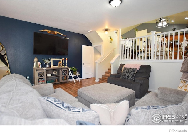 living room with stairway and wood finished floors