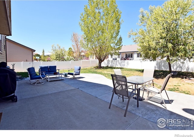 view of patio / terrace featuring an outdoor living space, a fenced backyard, and outdoor dining space