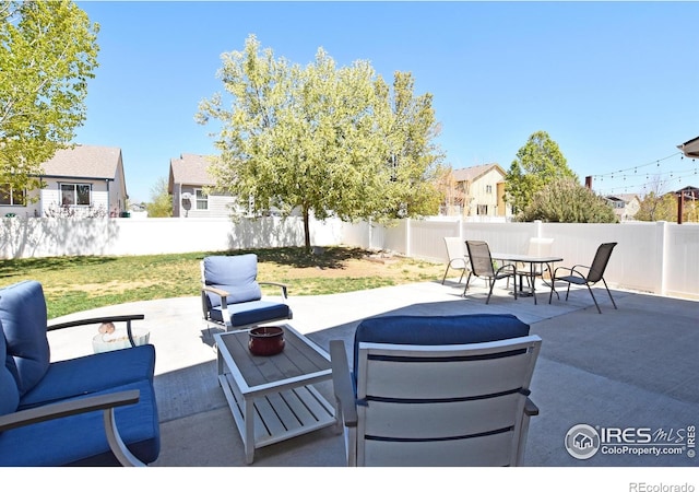 view of patio featuring outdoor dining area, a fenced backyard, and an outdoor hangout area