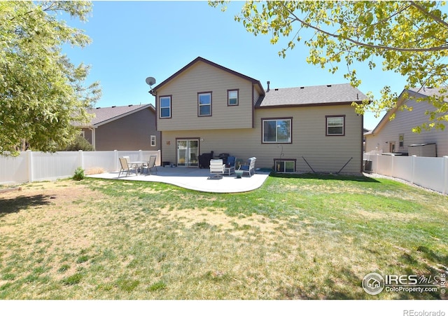 rear view of house featuring a fenced backyard, a patio area, and a yard