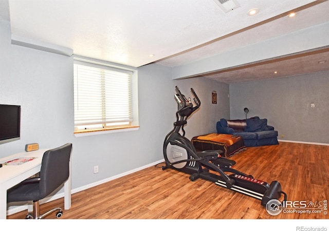 interior space with recessed lighting, baseboards, visible vents, and wood finished floors
