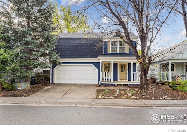 traditional-style house featuring roof with shingles, covered porch, driveway, and a garage