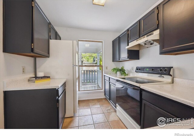 kitchen with white appliances, under cabinet range hood, and light countertops