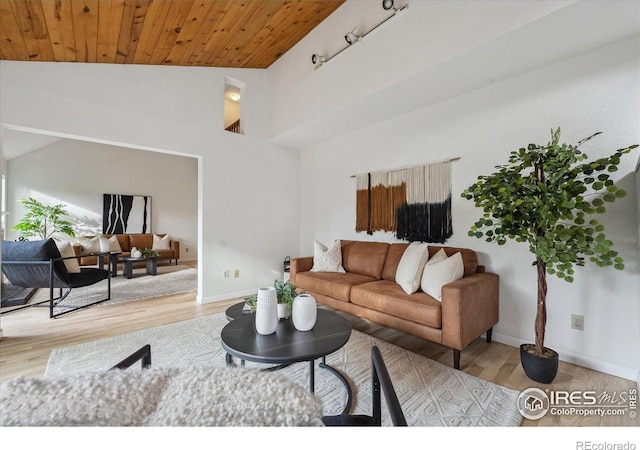 living room with wood ceiling, baseboards, wood finished floors, and lofted ceiling