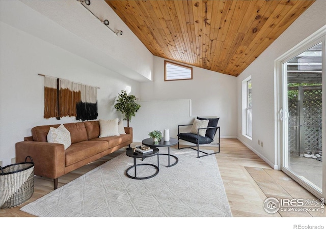 living area with a healthy amount of sunlight, wooden ceiling, light wood-style floors, and vaulted ceiling