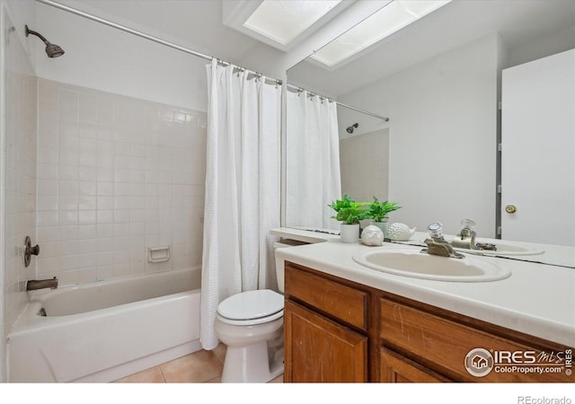 full bath with vanity, tile patterned flooring, shower / bath combo with shower curtain, and toilet
