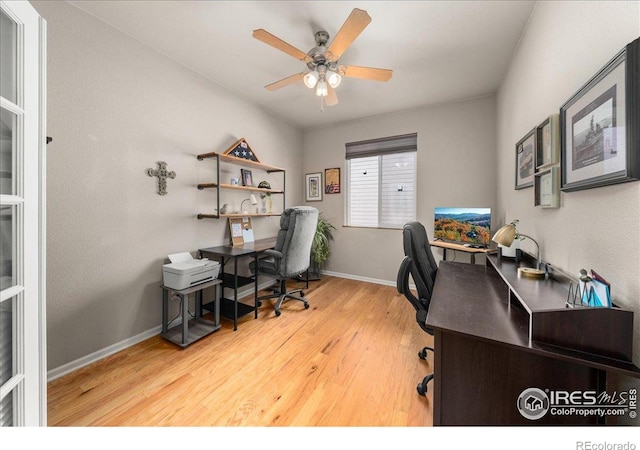 office featuring wood finished floors, baseboards, and ceiling fan