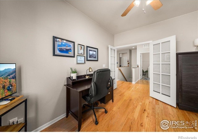 office space with visible vents, wood finished floors, baseboards, and ceiling fan