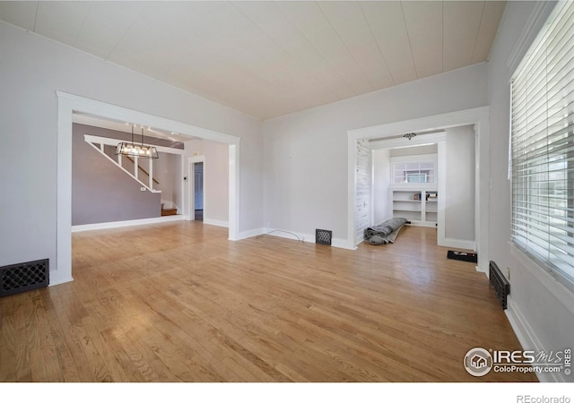 405 Maple St, Fort Morgan, CO 80701 - spare room featuring light wood-type flooring, stairway, and baseboards