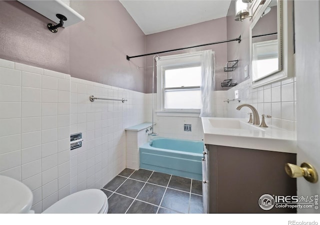 405 Maple St, Fort Morgan, CO 80701 - full bath featuring tile walls, toilet, tile patterned floors, bathtub / shower combination, and wainscoting