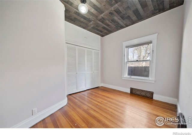 405 Maple St, Fort Morgan, CO 80701 - unfurnished bedroom with a closet, baseboards, wood-type flooring, and wooden ceiling