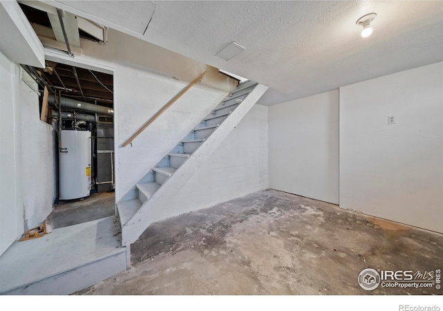 405 Maple St, Fort Morgan, CO 80701 - unfinished below grade area featuring gas water heater, stairs, and a textured ceiling