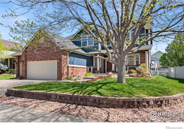view of front of property with a front yard, a garage, brick siding, fence, and concrete driveway