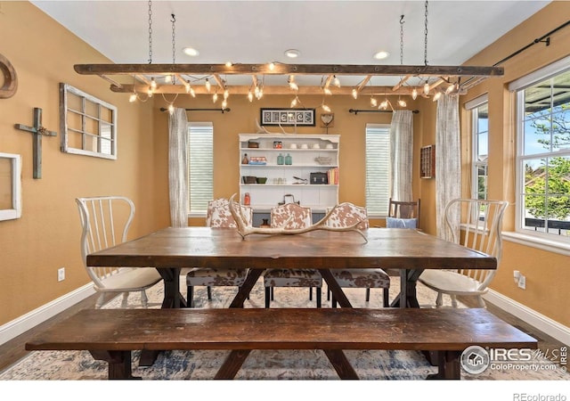 dining area featuring baseboards, recessed lighting, and wood finished floors