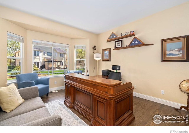 office area with baseboards and dark wood-style floors