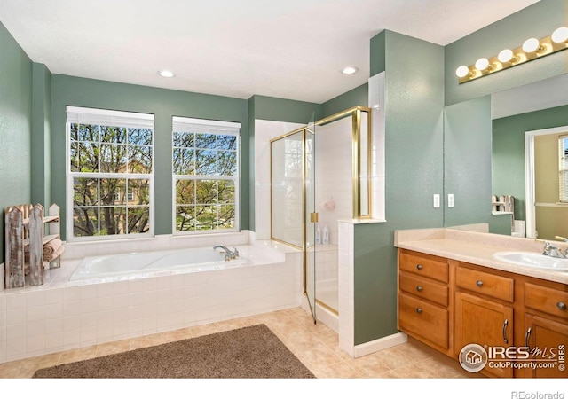 bathroom featuring vanity, tile patterned flooring, a garden tub, and a stall shower