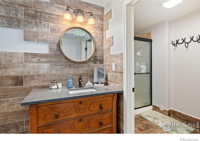 full bathroom with a shower stall, tasteful backsplash, and vanity