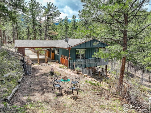 4 Porphyry Vw, Jamestown, CO 80455 - rear view of house featuring board and batten siding and a view of trees