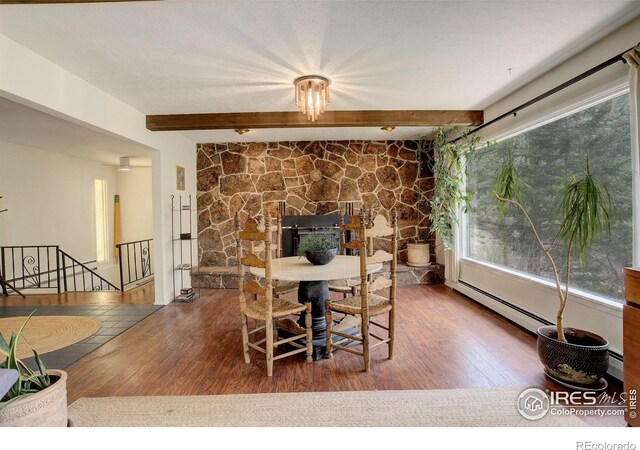4 Porphyry Vw, Jamestown, CO 80455 - dining room with wood finished floors, beam ceiling, and a fireplace