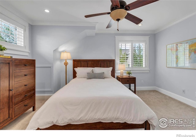 bedroom with baseboards, multiple windows, light carpet, and ornamental molding