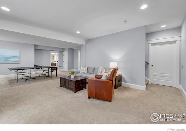carpeted living area with baseboards, recessed lighting, and stairway