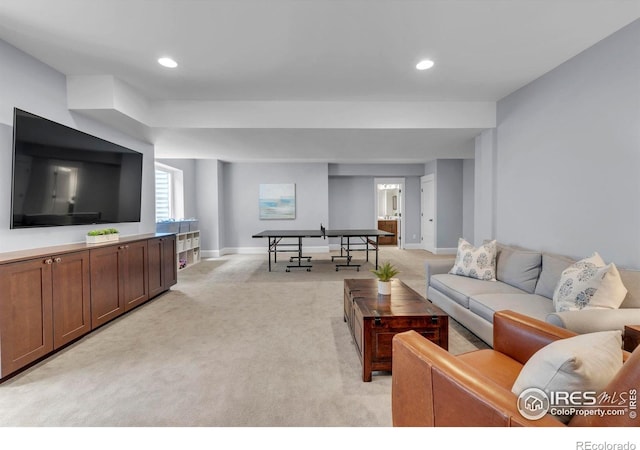 living area featuring recessed lighting, baseboards, and light carpet